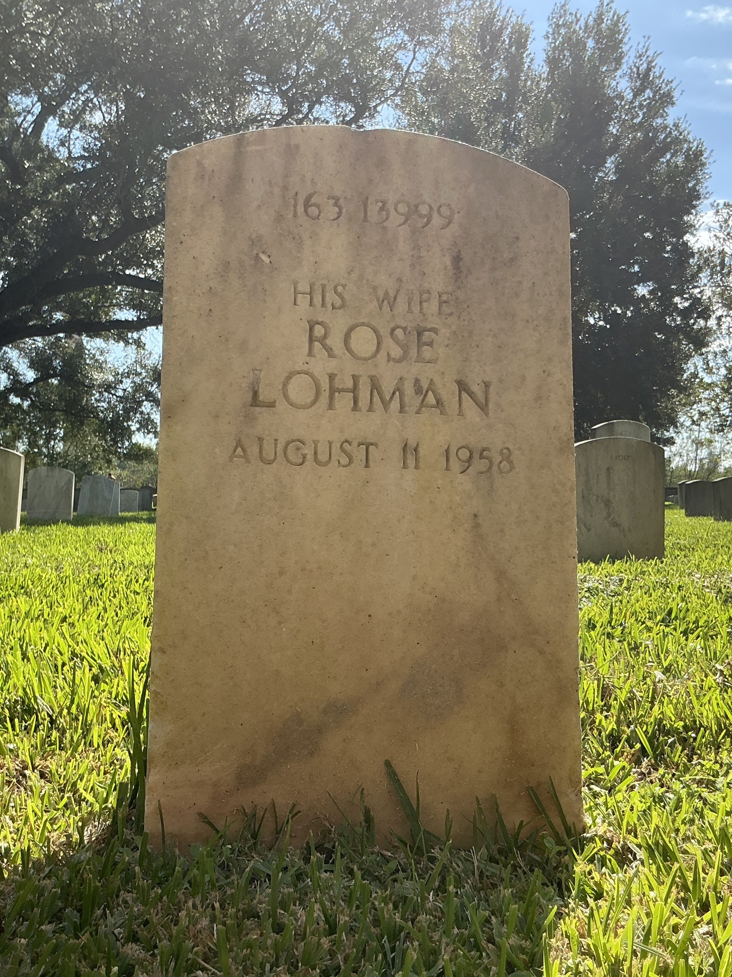 Back of upright marble headstone with flat face.