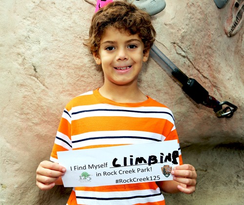 A young boy holding a sign that says 