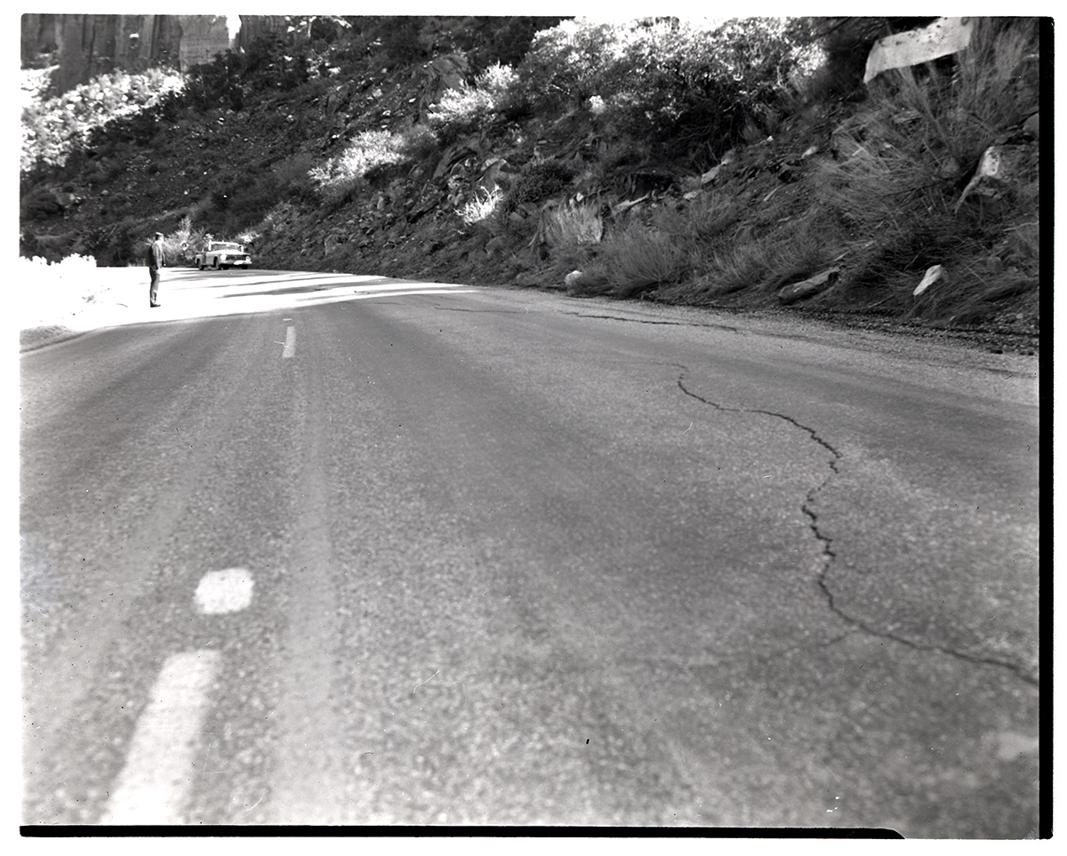 Man observing road along the Zion-Mt. Carmel Highway switchbacks.