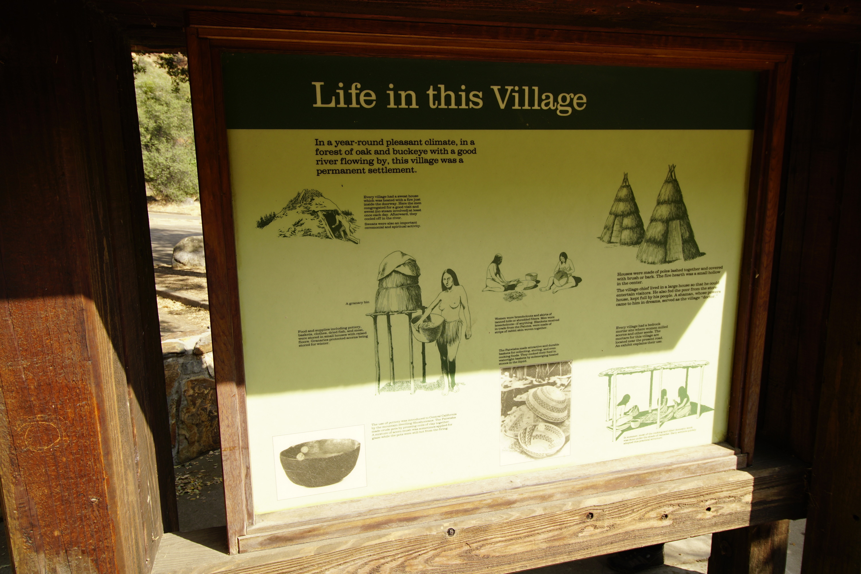 a yellow metal panel sits in a wooden frame 