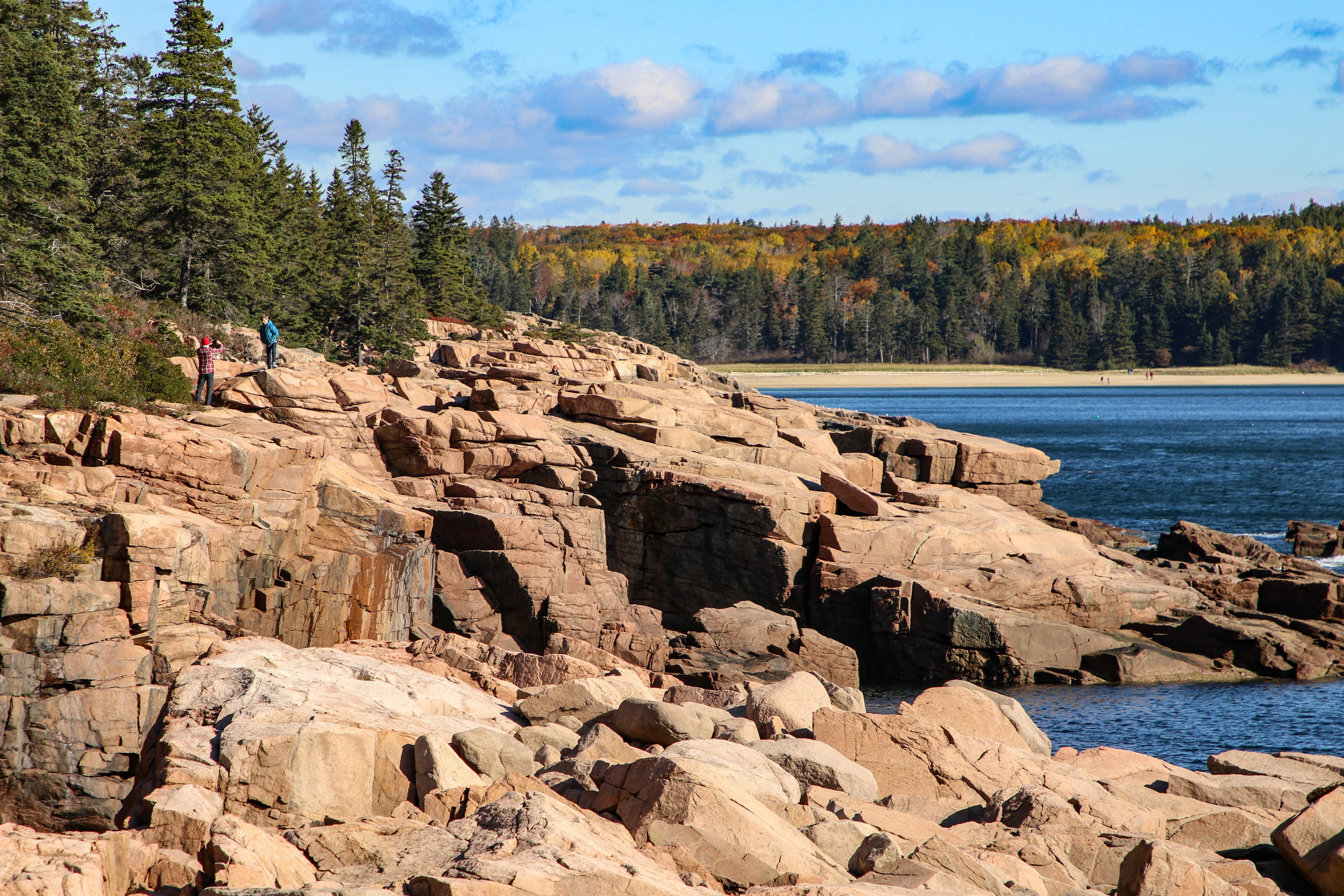 Visitors climbing on a rocky coastline