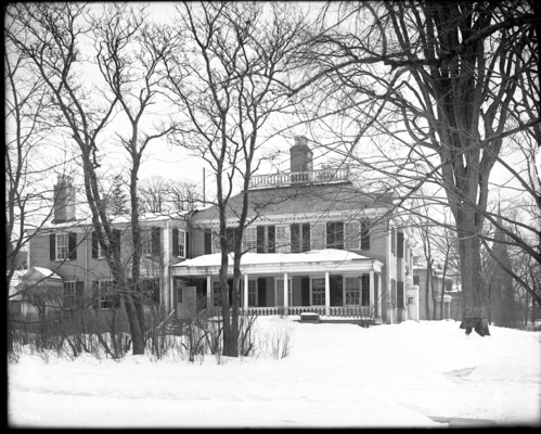 Black and white photograph of Georgian mansion in the snow.