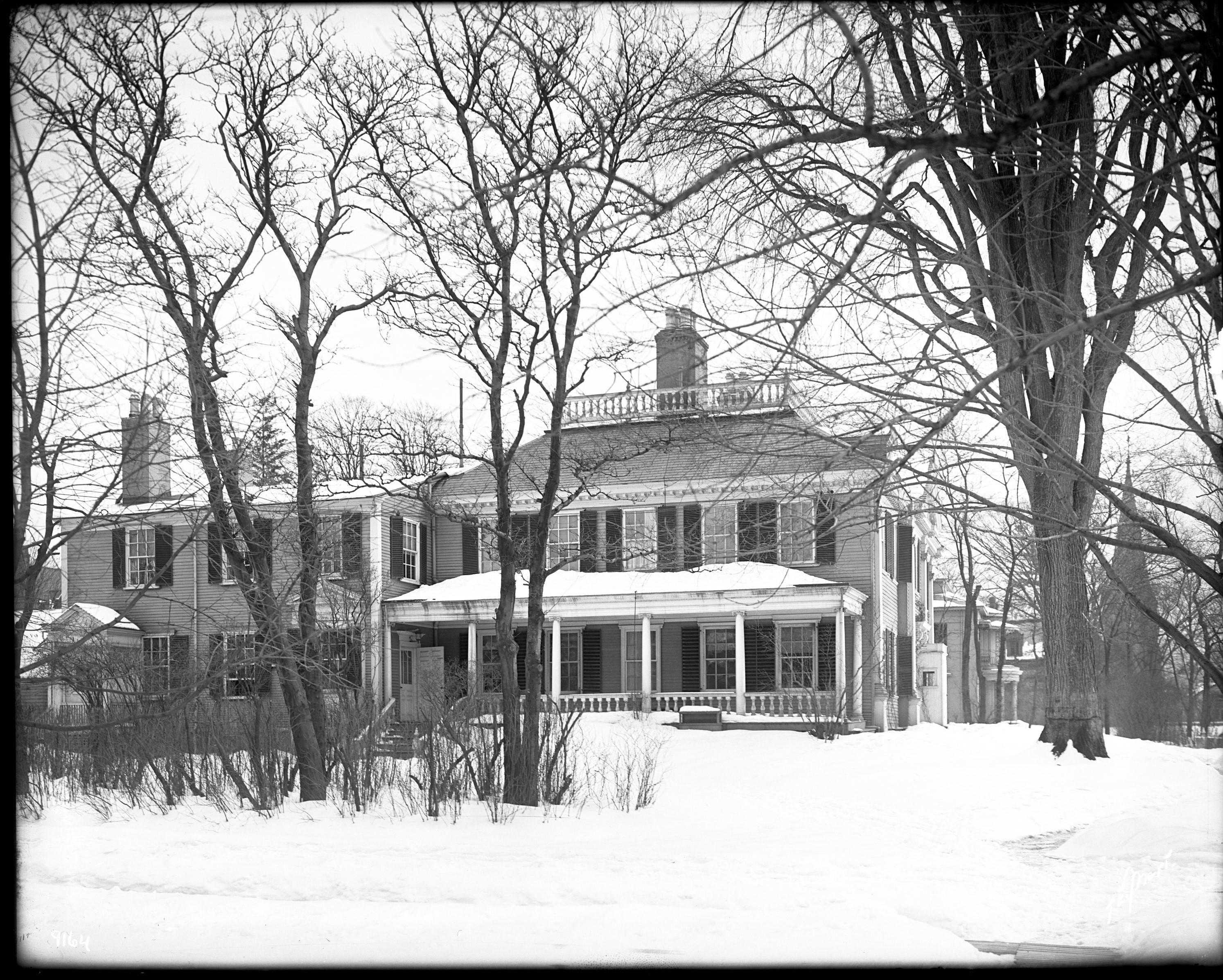 Black and white photograph of Georgian mansion in the snow.