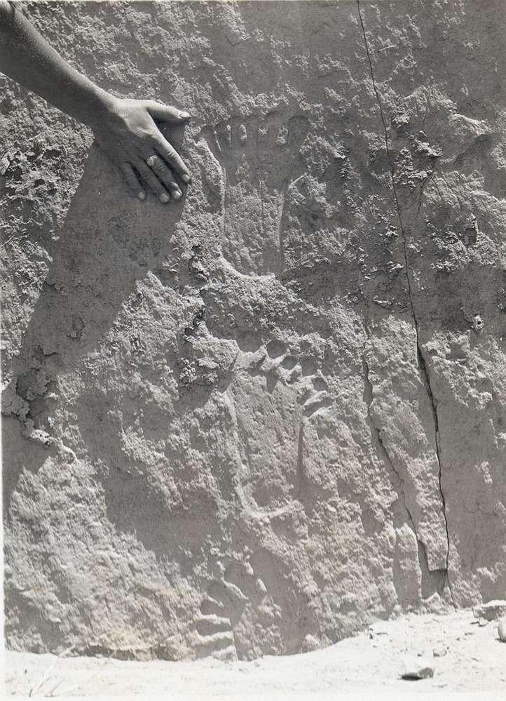 Photo of petroglyph of three six-toed feet, found along the cliff face behind Pueblo Bonito.