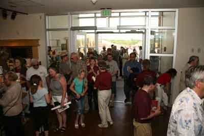 A large group of visitors in the Heritage Center lobby.