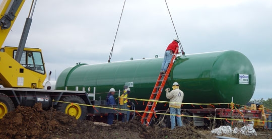 Preparing Fire Suppression Tank for insertion through hole in lower level wall.