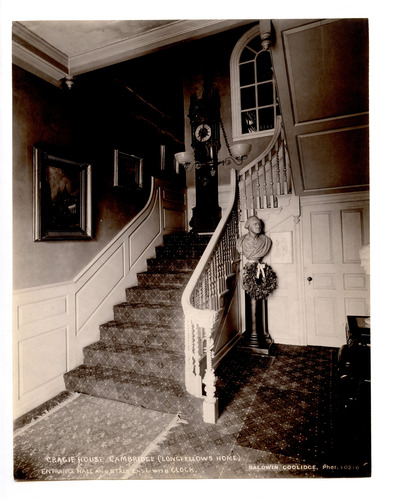 Stairs with clock and bust of George Washington.
