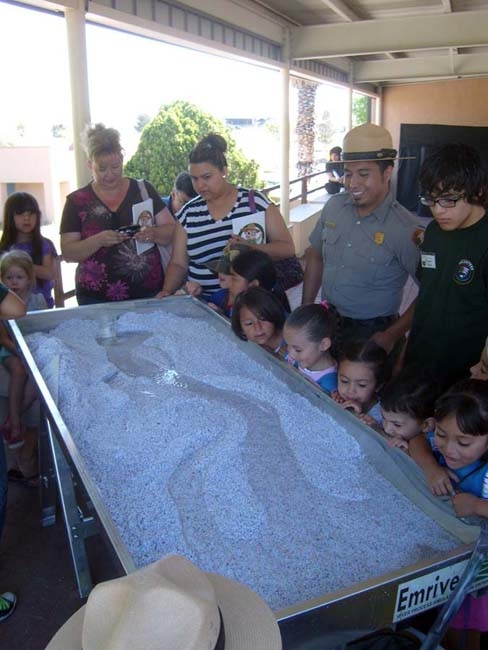 Ranger JR giving water table talk to Junior Rangers