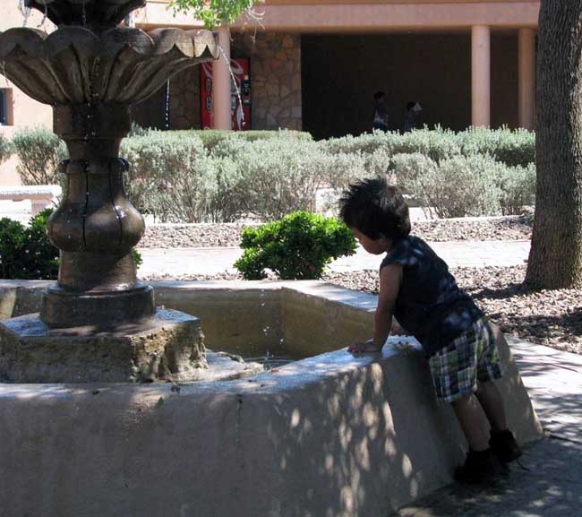 After a full day at the memorial, a Junior Ranger cools off at the Spanish Garden Fountain.