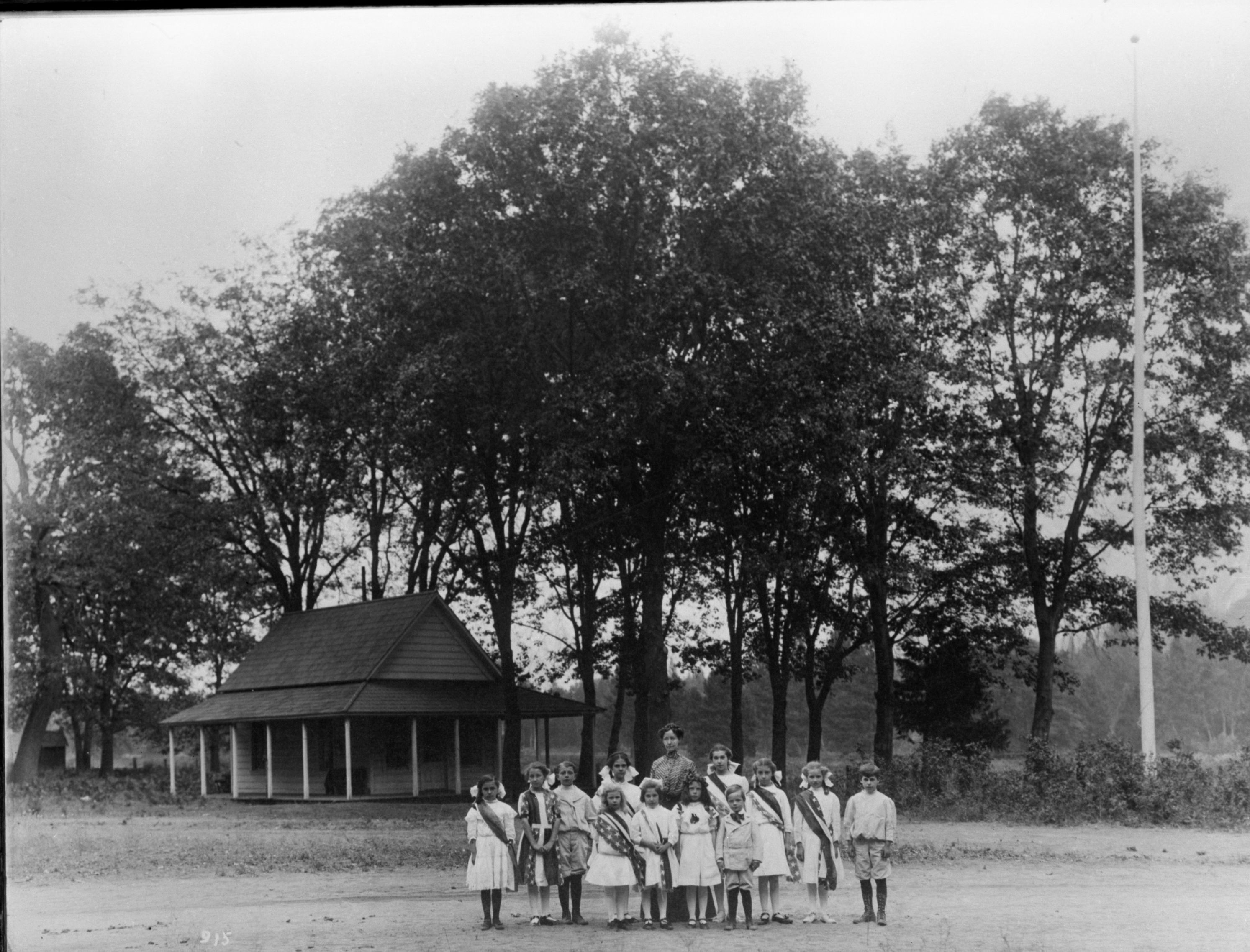 Plate underneath picture on frame: "Yosemite Valley School, Year 1910. Miss Katherine E. Dexter, Teacher. [List of students in 3 columns] Grace Lillian Greenwood, Amy Ellen Boysen, Harlow George Parks, Virginia Rose Best, Thursa Aline Foley, Florence M. Sovulewski, Alice Regina Degnan, Eugene Howard Tucker, Grace C. Sovulewski, Lillian May Park, Evelyn A. Tucker, Lawrence G. Sovulewski"