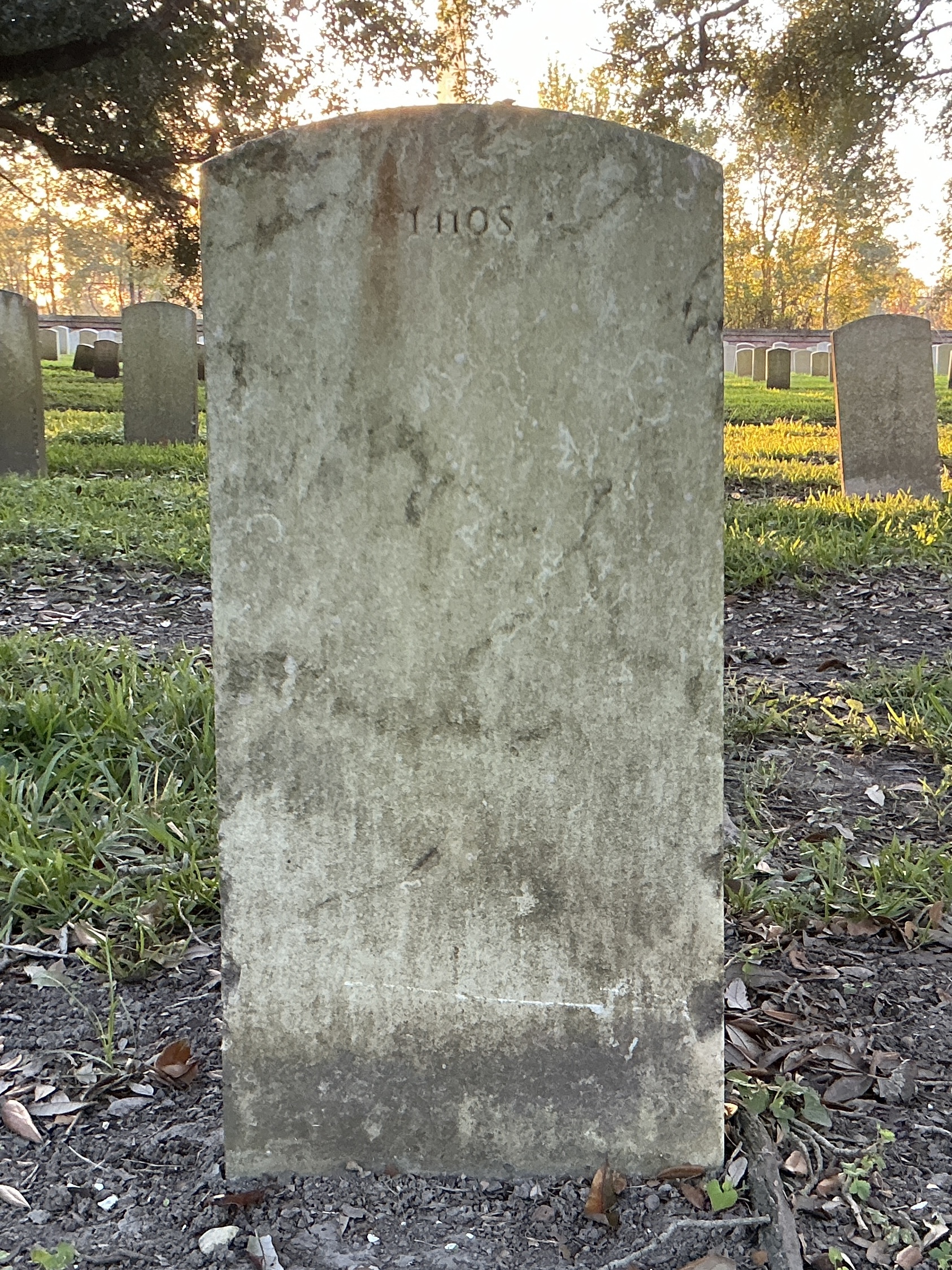 Back of upright marble headstone with flat face.