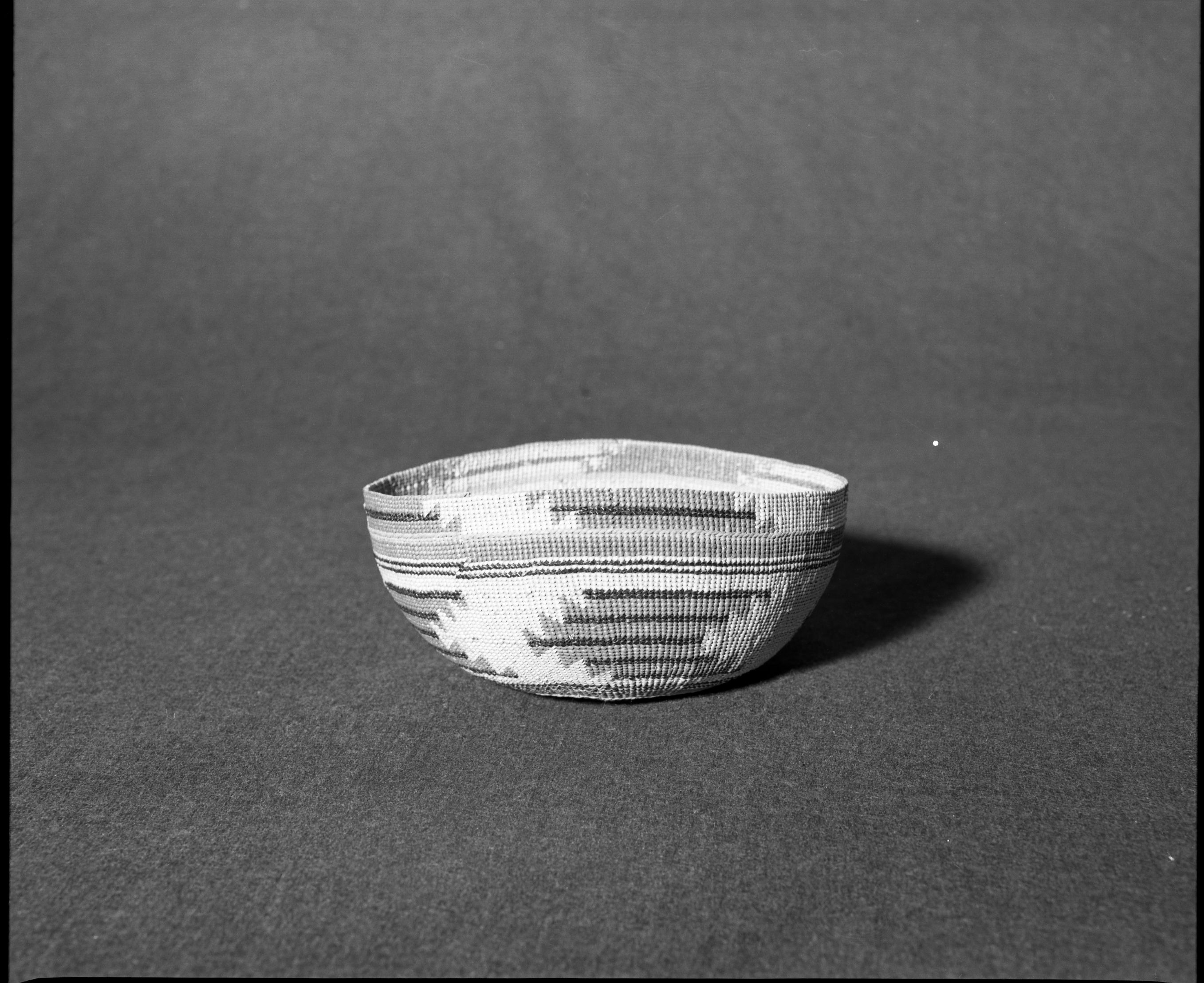 Marie Rozier Collection, Catalog No. 131. Object: Yurok/Karok/Hupa hat. Dimensions: 7 x 3 1/2". Materials: Conifer root, beargrass, maidenhair fern stem, alder bark dyed-woodwardia fern stem. Collection History: From Mrs. Long's Collection. Collected between 1890 and 1910. Photographed by Michael Dixon in December 1982. Catalogued by Craig Bates and Barbara Beroza. Yosemite Collections, National Park Service.