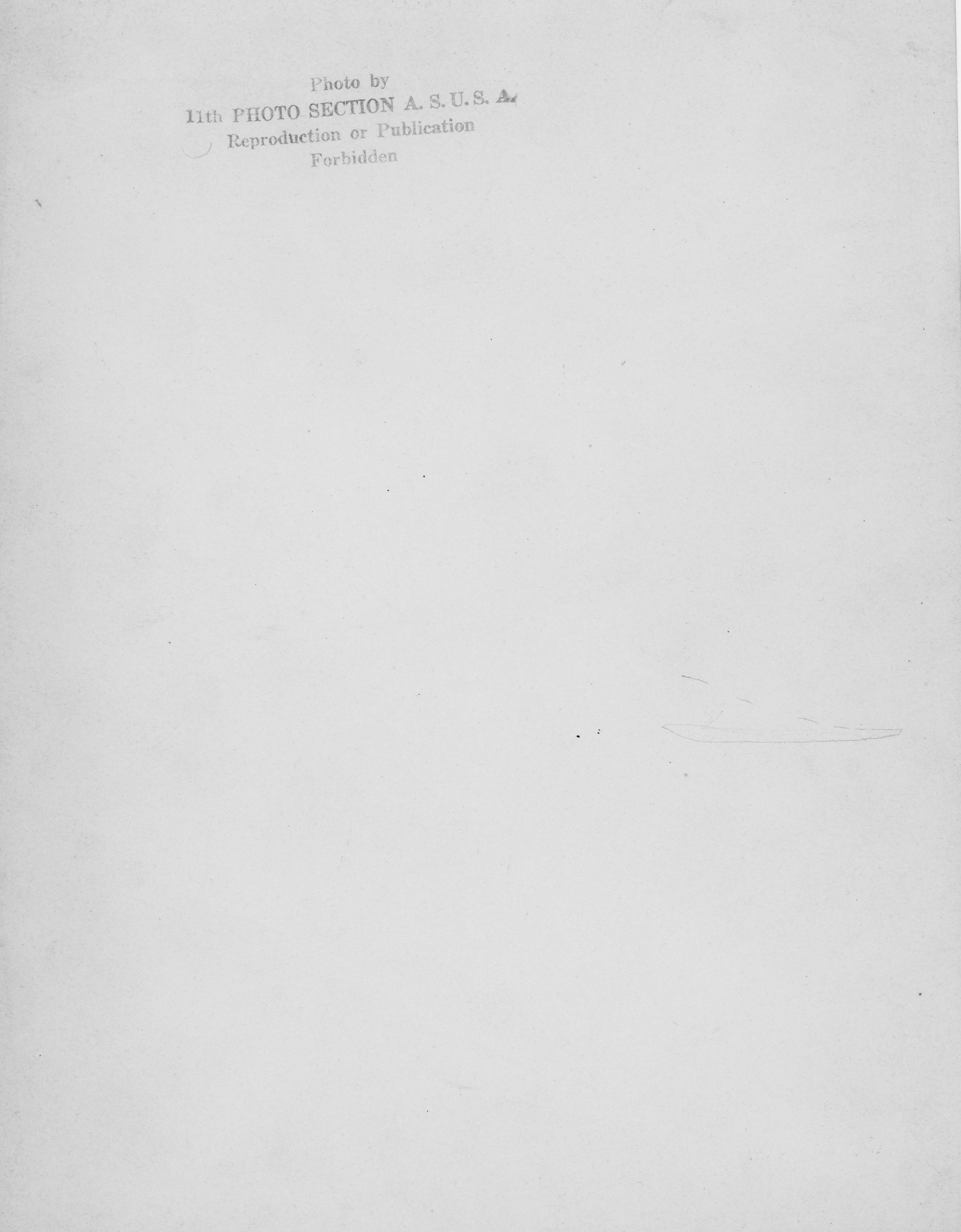 Reverse side of a photograph, stamped writing reads, "Photo by 11th Photo Section A. S. U.S.A. Reproduction or Publication Forbidden."