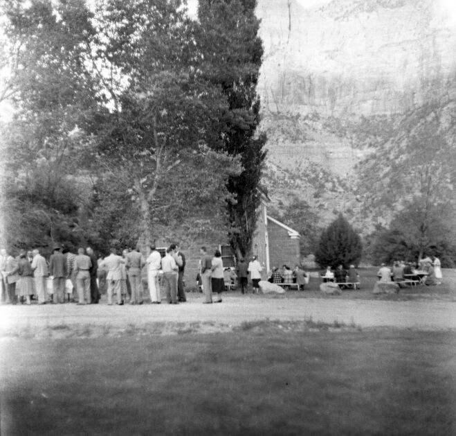 Men and women from the Fire Conference gathered outside for barbecue feast, April 1957. Near ranger dormitory.