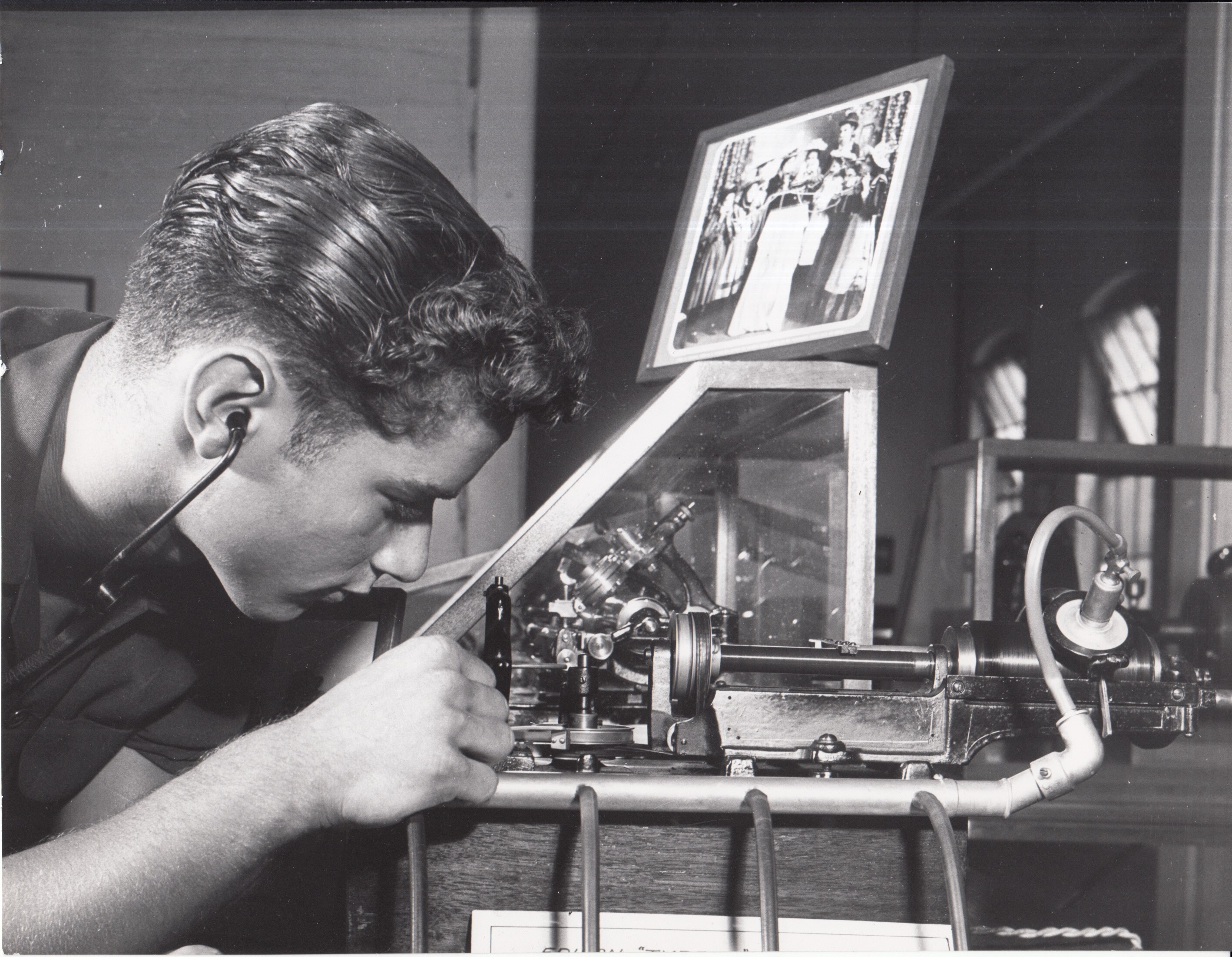 Visitor listening to Edison cylinder phonograph on display at Edison Museum.
