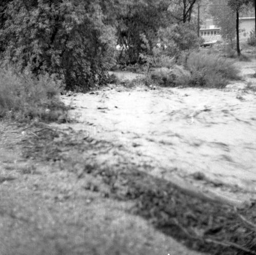 The flood damage from down pour - 1.38-inches in one hour high water in Oak Creek near bridge adjacent to employee's parking area (Mission 66 Visitor Center and Museum and State Route 9).