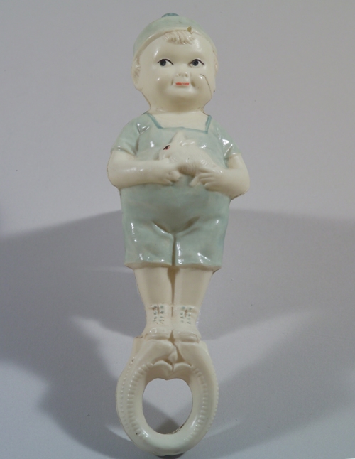 Hollow, celluloid baby rattle of small boy. Belonged to Margaret Truman, circa 1925. HSTR 25042.
