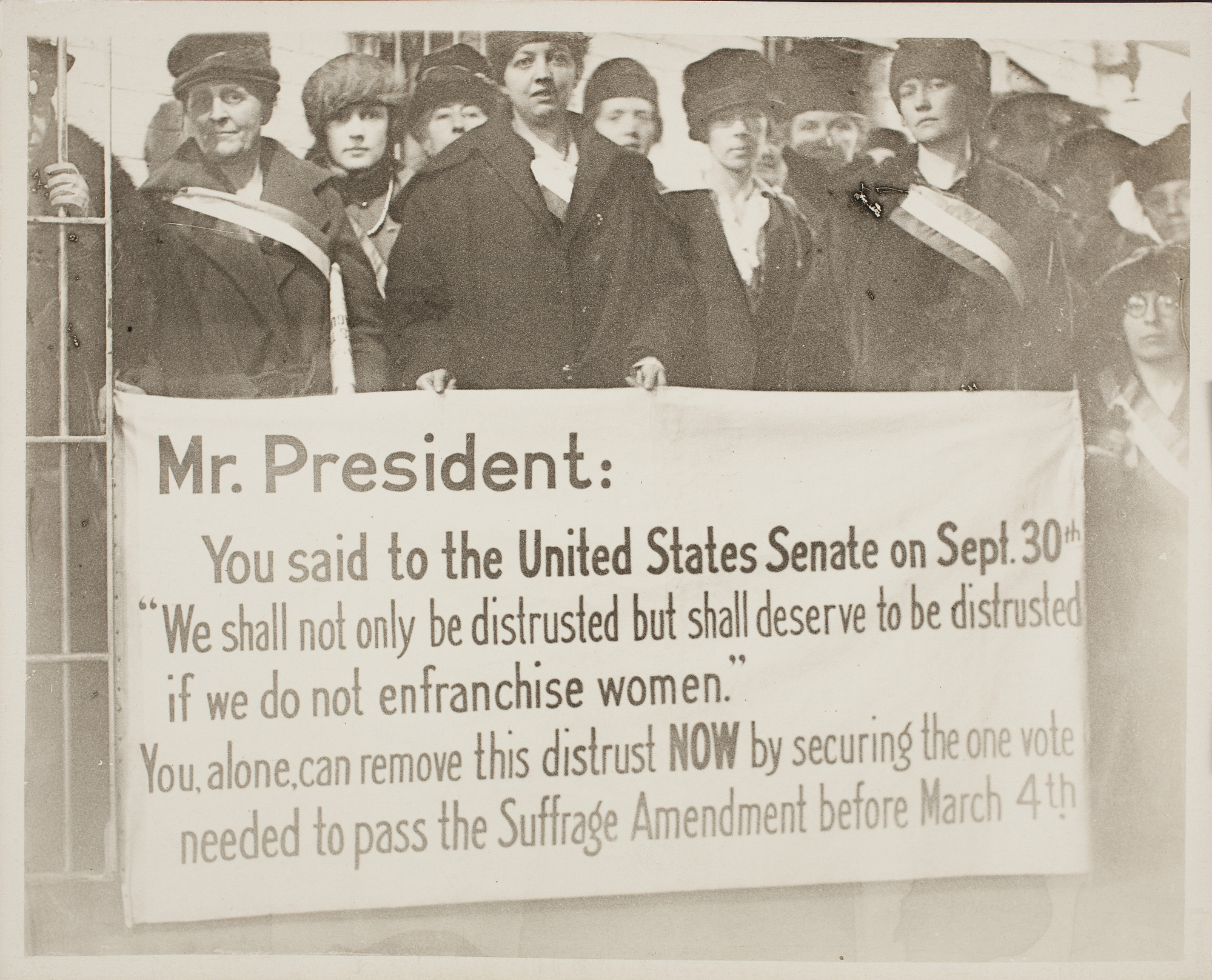 Suffragists with a protest banner during President Wilson's visit to Boston, Mass., Feb. 1919.