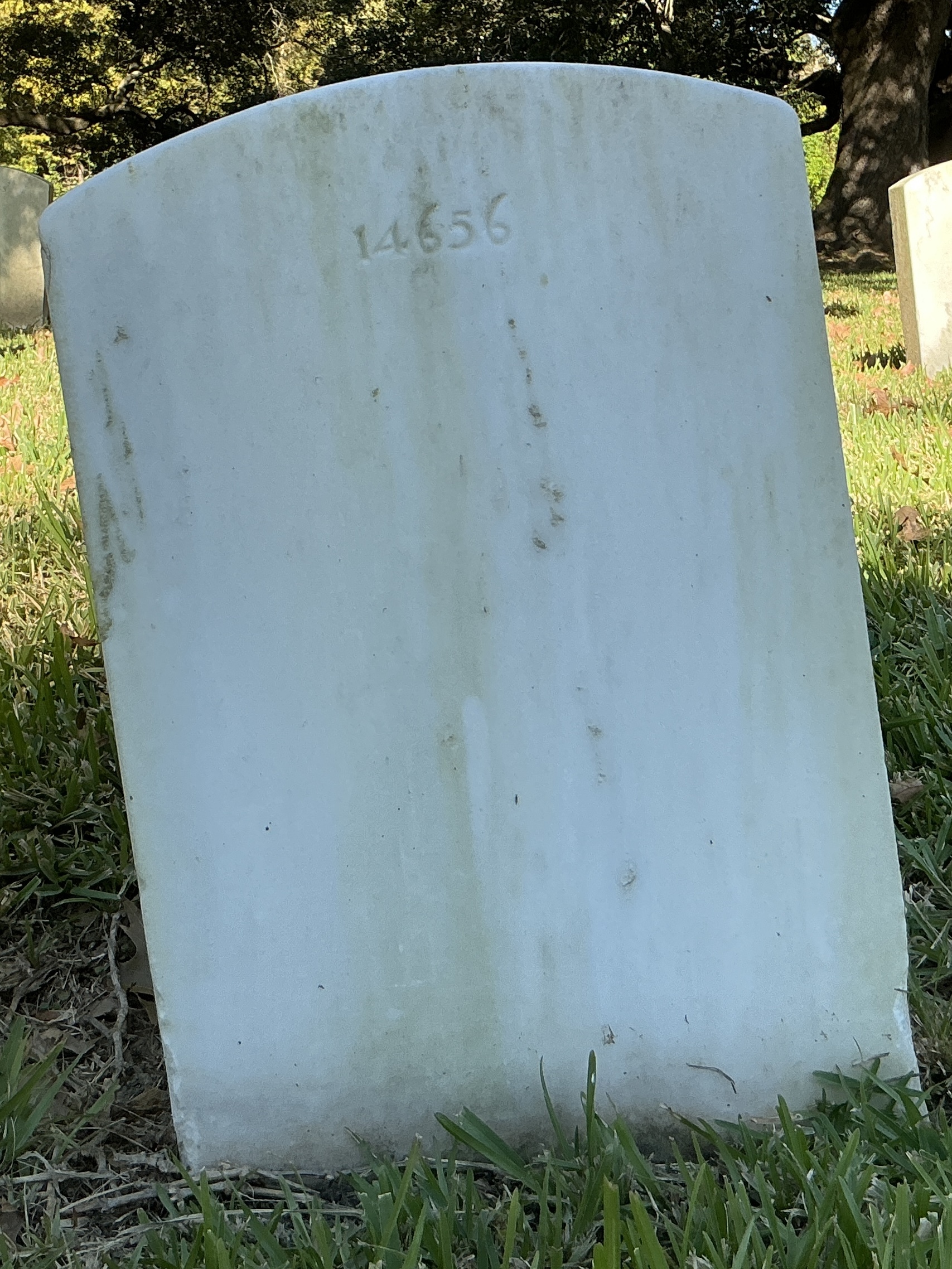 Back of upright marble headstone with flat face.
