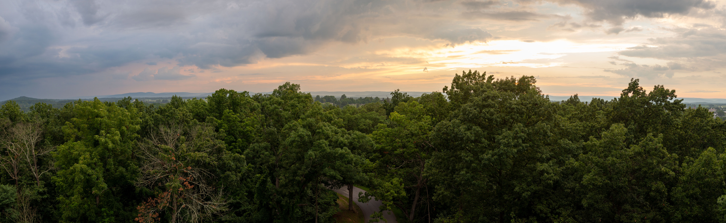 A panoramic view from Culp's hill observation tower with cloudy skies and trees below.