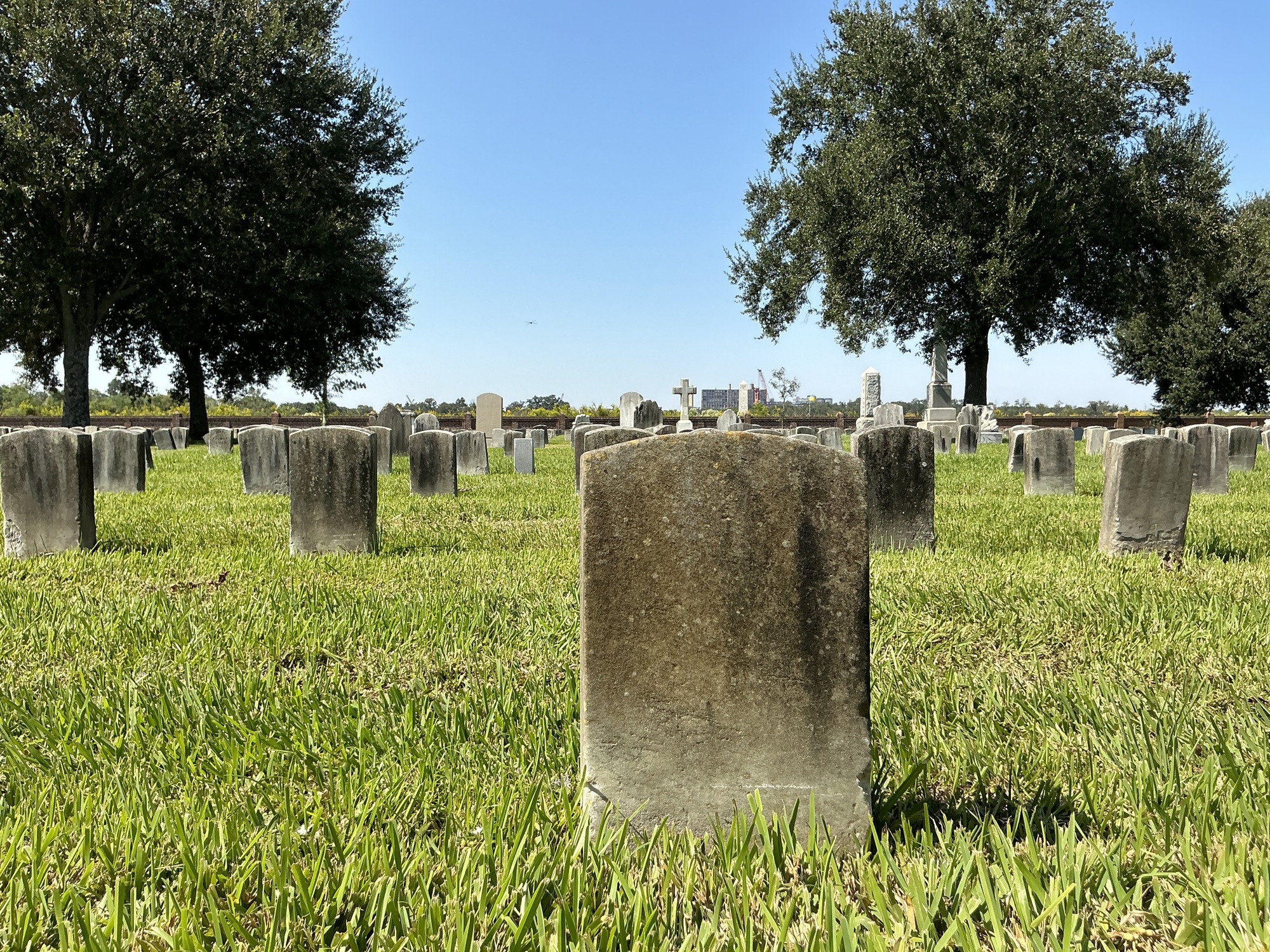 Back of historic upright marble headstone with recessed shield face.