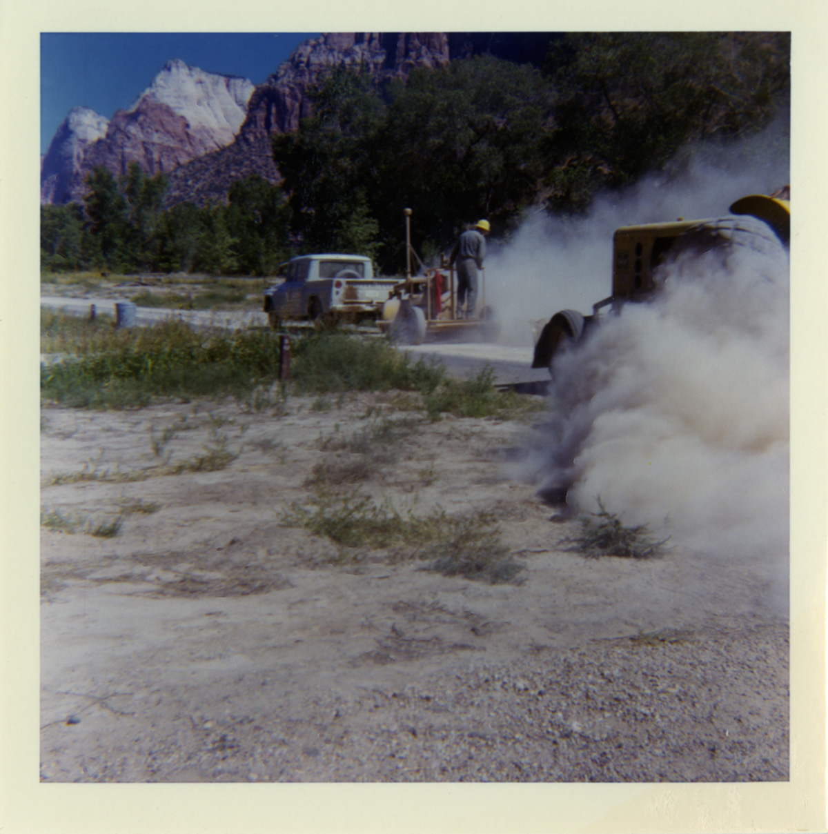 Man working on chipsealing the road.
