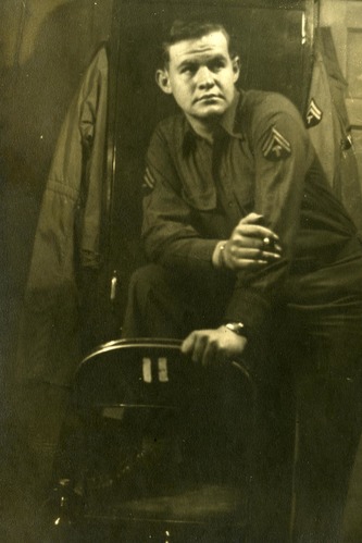 Uniformed man leaning on a chair