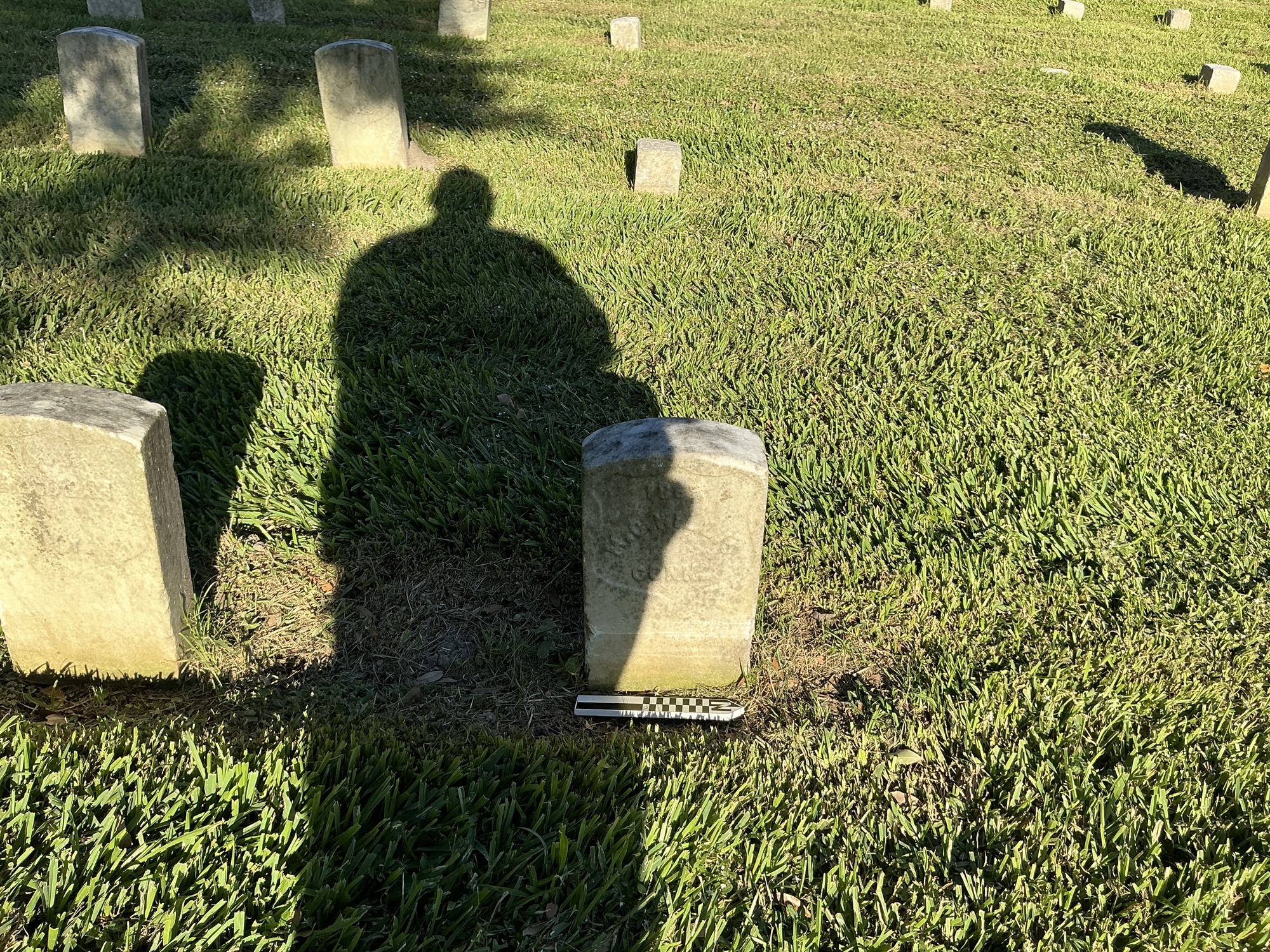 Extra image of historic upright marble headstone with recessed shield face.