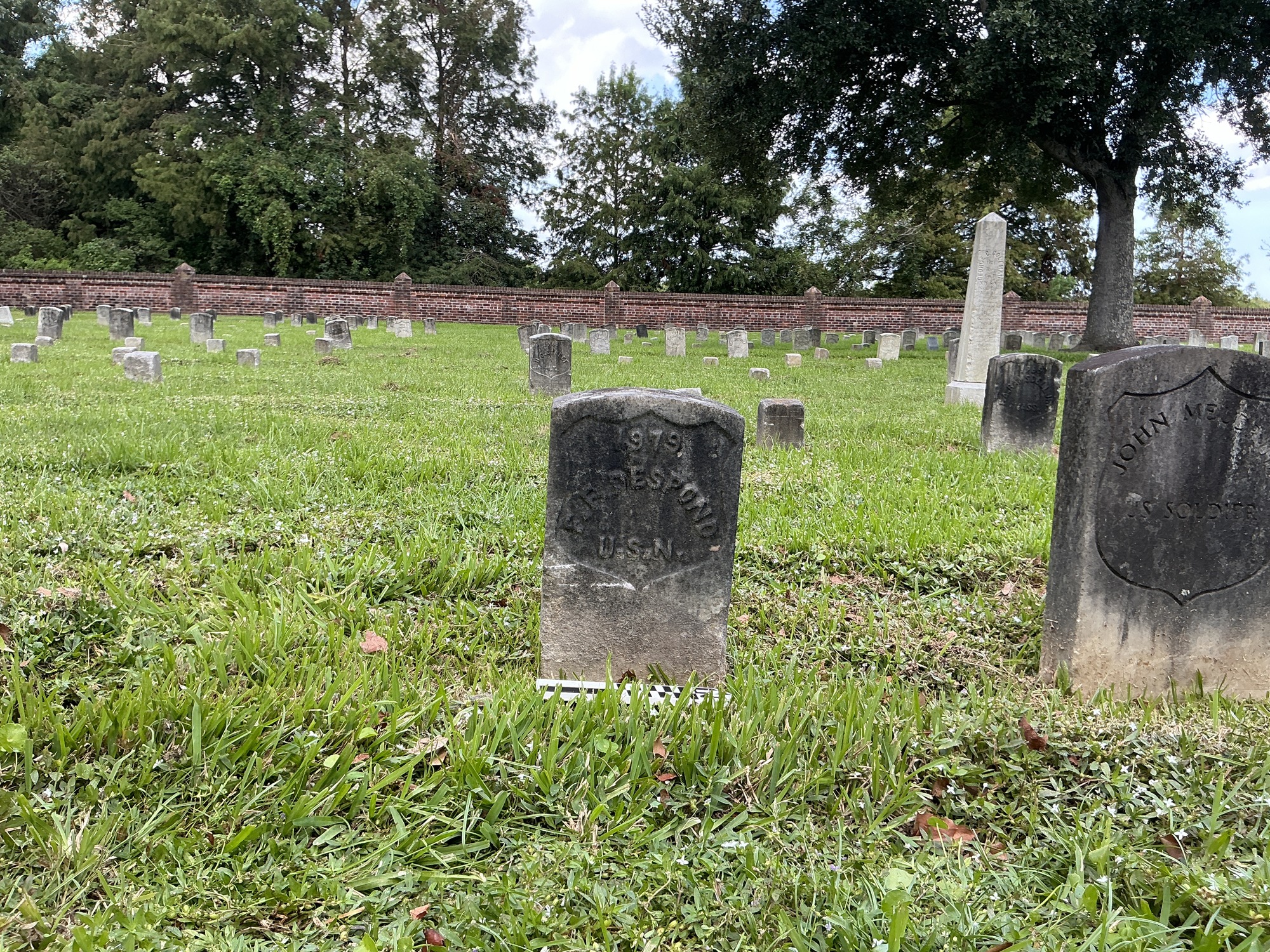 Extra image of historic upright marble headstone with recessed shield face.