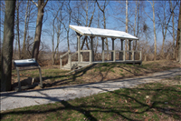 Replica of Simms Station at Huffman Prairie Flying Field. This photograph depicts a modern replica of the platform at Simms Station along the trace of the Dayton, Springfield and Urbana interurban line used by the Wright brothers to travel from their home in west Dayton to the Huffman Prairie Flying Field northeast of the city.  This land is now part of Wright-Patterson Air Force Base and Dayton Aviation Heritage National Historical Park.