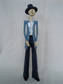 The clay figurines are a traditional folk art found all over Mexico and can depict either female (Catrina) or male (Catrin) figures, like this one.