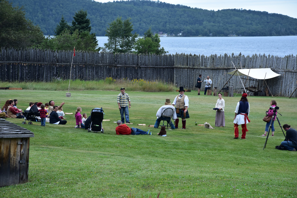 Visitors and reenactors enjoy a throwing contest in the great hall yard.