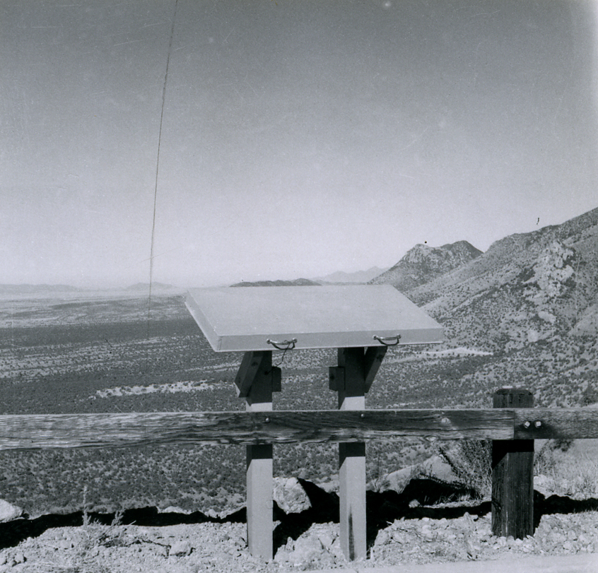 A wayside exhibit at an overlook, a broad valley in the distance