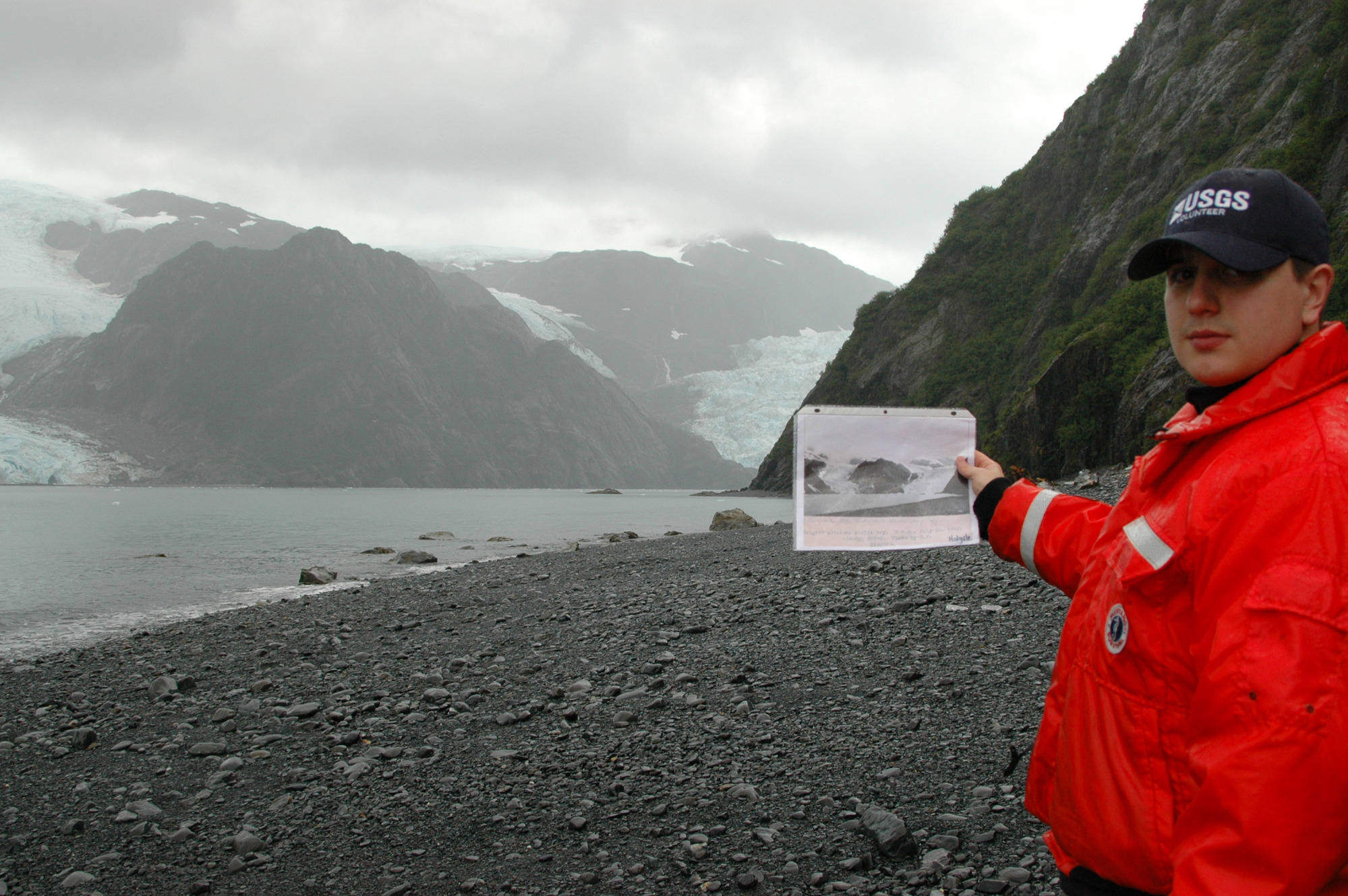Researcher holds up repeat photography at Holgate Glacier 2005