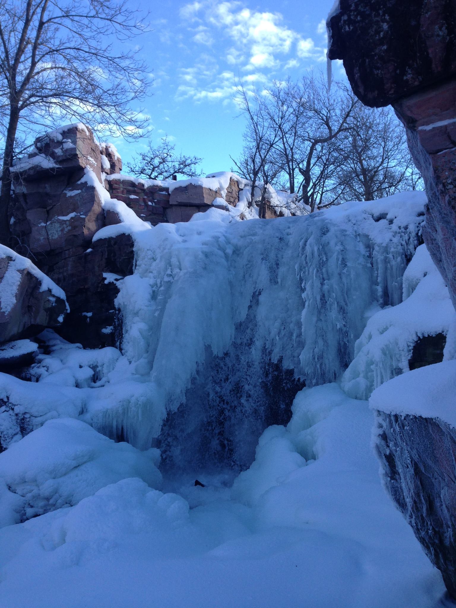 Frozen waterfall on sunny winter day