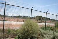 A fence with barbed wire.