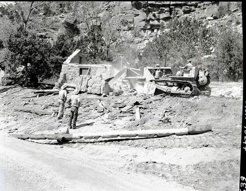 Realignment of Highway 1 - demolition of museum building with bulldozer.