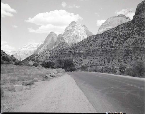 Proposed site for new Mission 66 Visitor Center and Museum, view northeast. From right to left: East Temple, Mount Spry, Twin Brothers, and Mountain of the Sun.