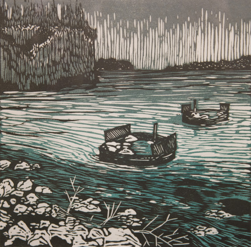 circular crib docks emerging from the water with a rocky cliff-faced island looming behind