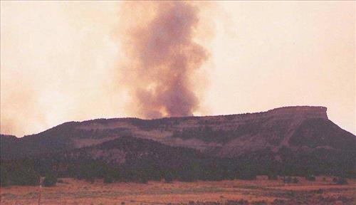 Intense burning with heavy gray and black smoke and flames during the Bircher fire, Mesa Verde National Park, July 2000