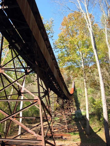 old rusted coal conveyor climbing up side of gorge