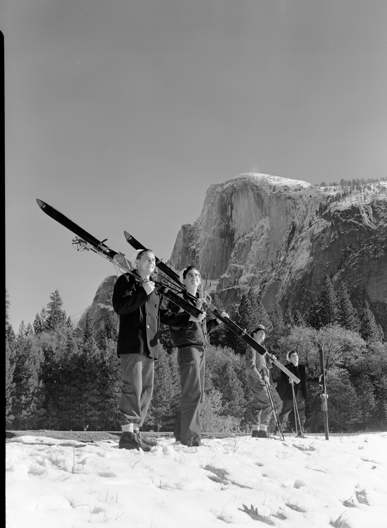 Navy men with skis in front of Half Dome.