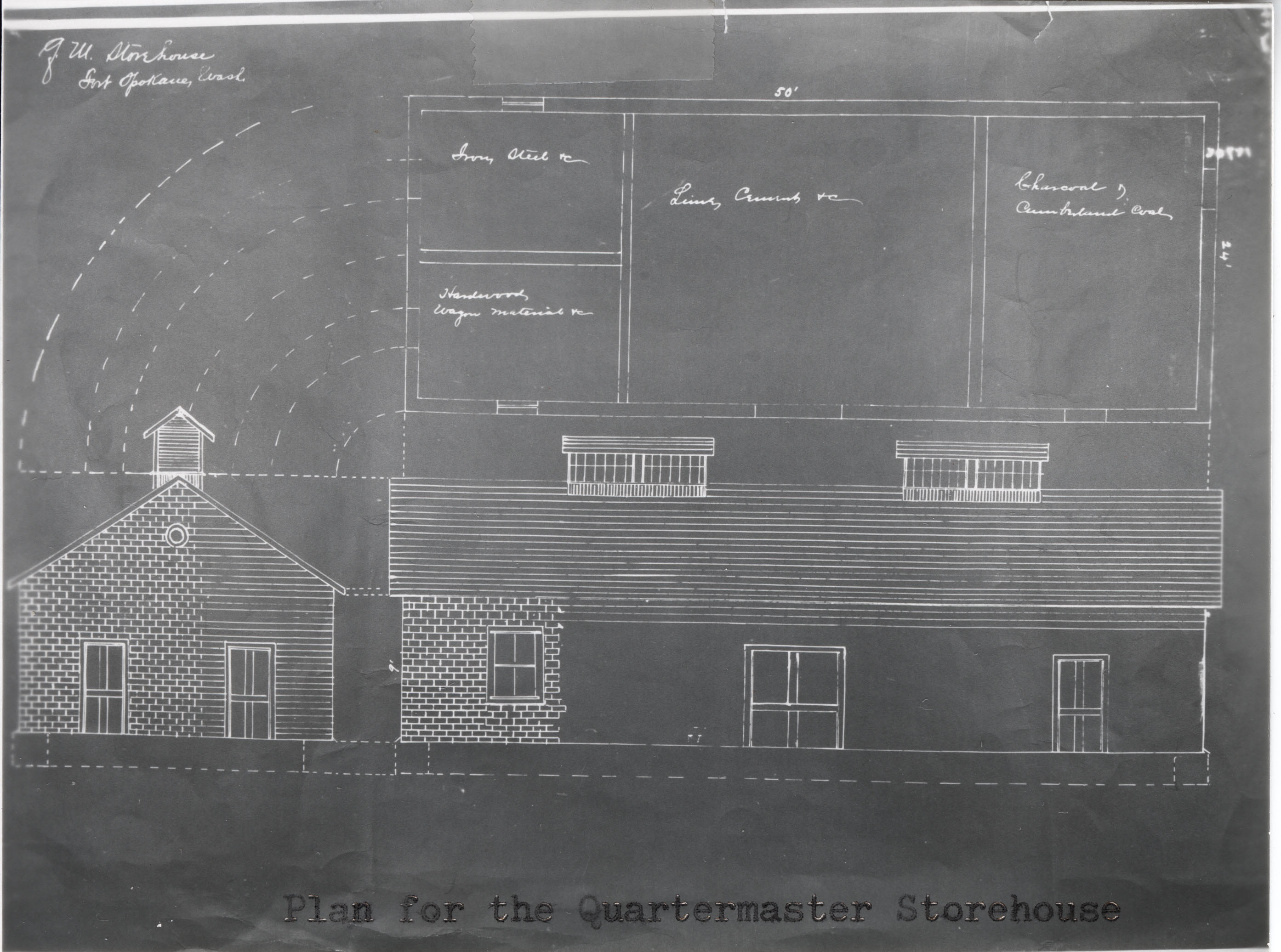 Black and white negative of a floorplan for a long rectangular brick building
