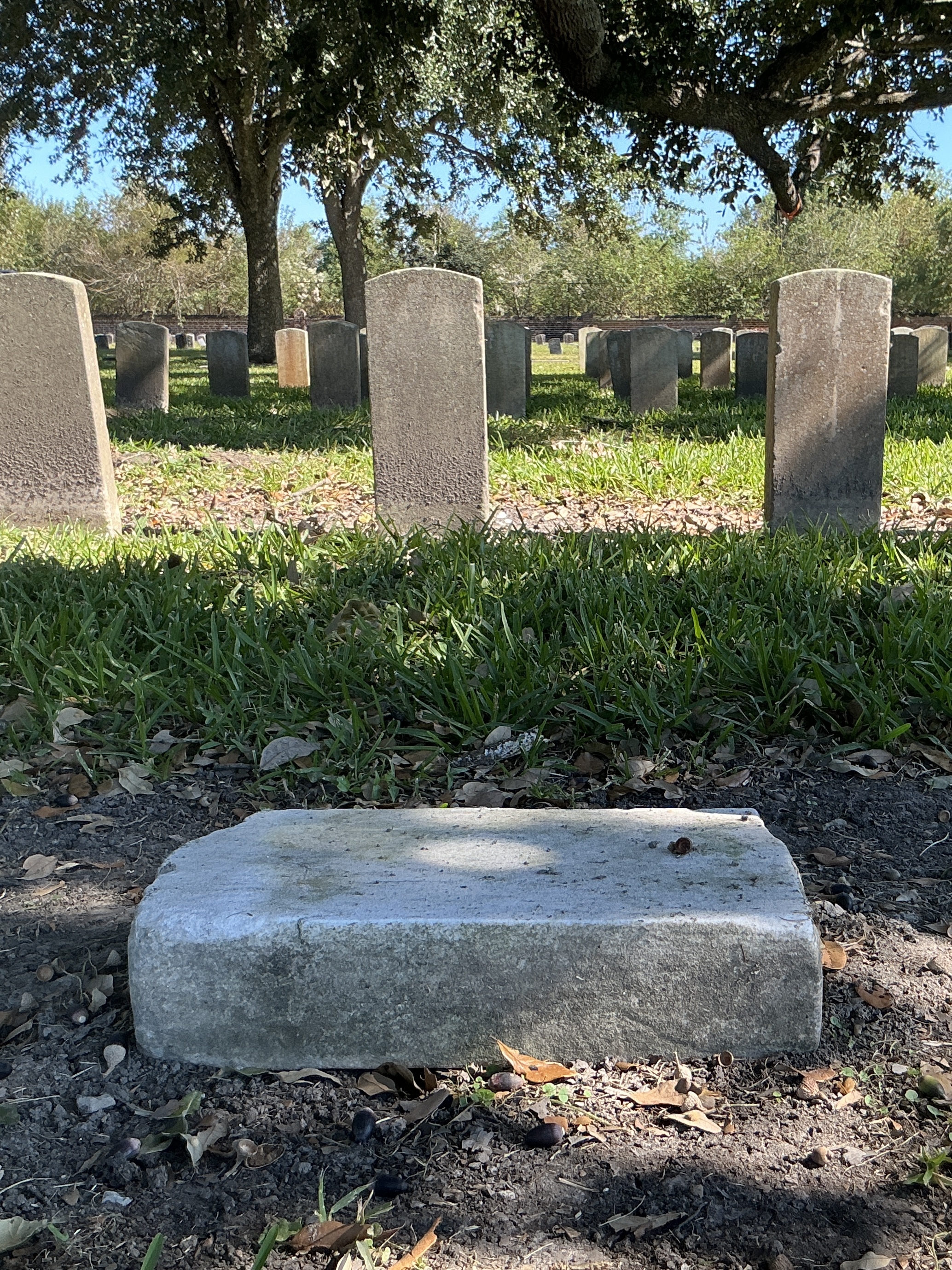 Back of historic upright marble headstone with other face.