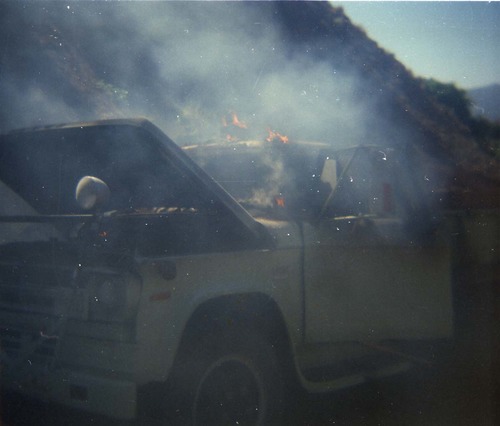 Color photo of an engine fire in a pickup.
