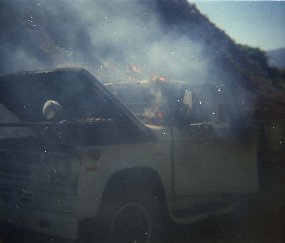 Color photo of an engine fire in a pickup.