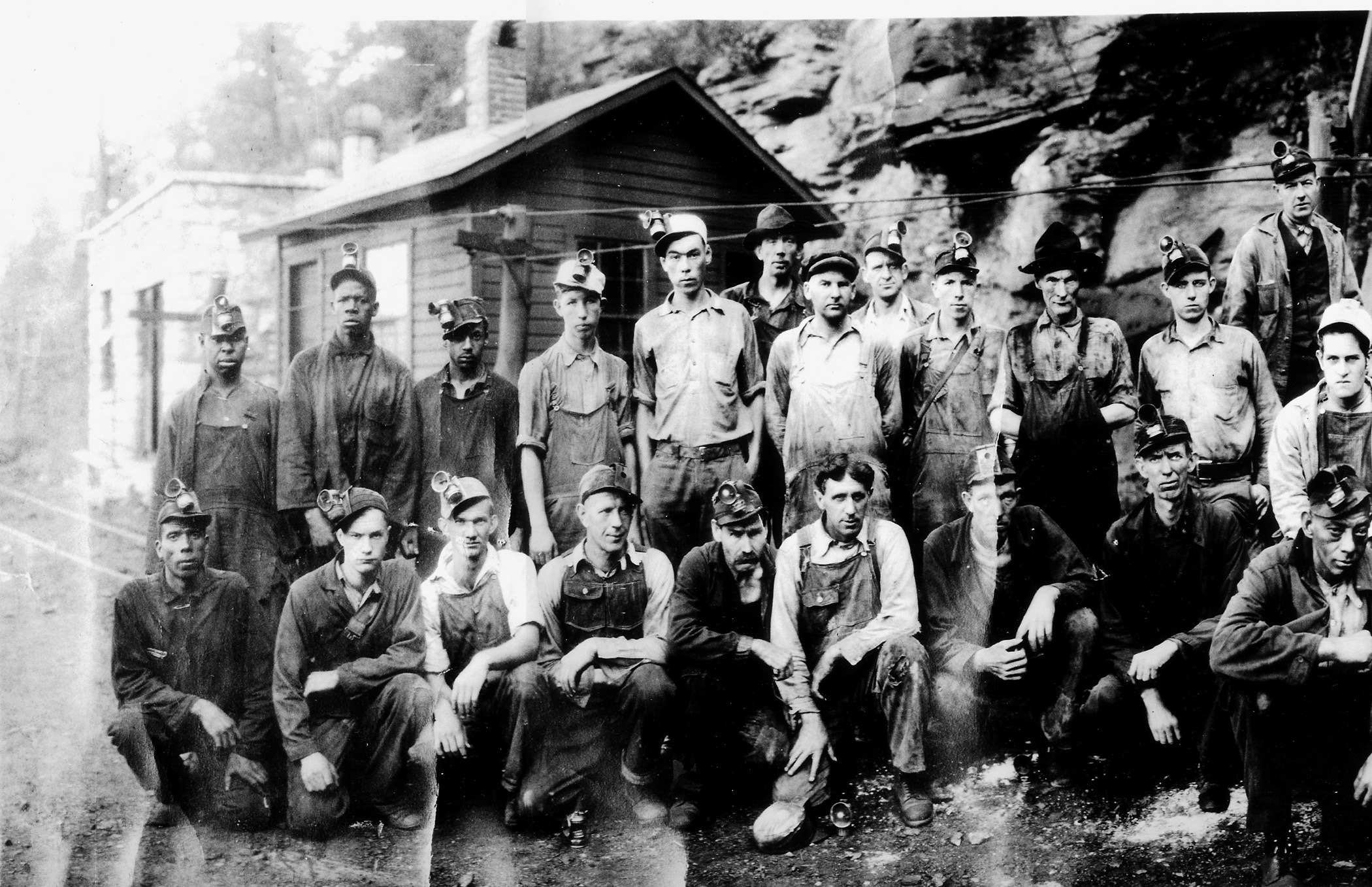 coal miners pose outside a coal mine