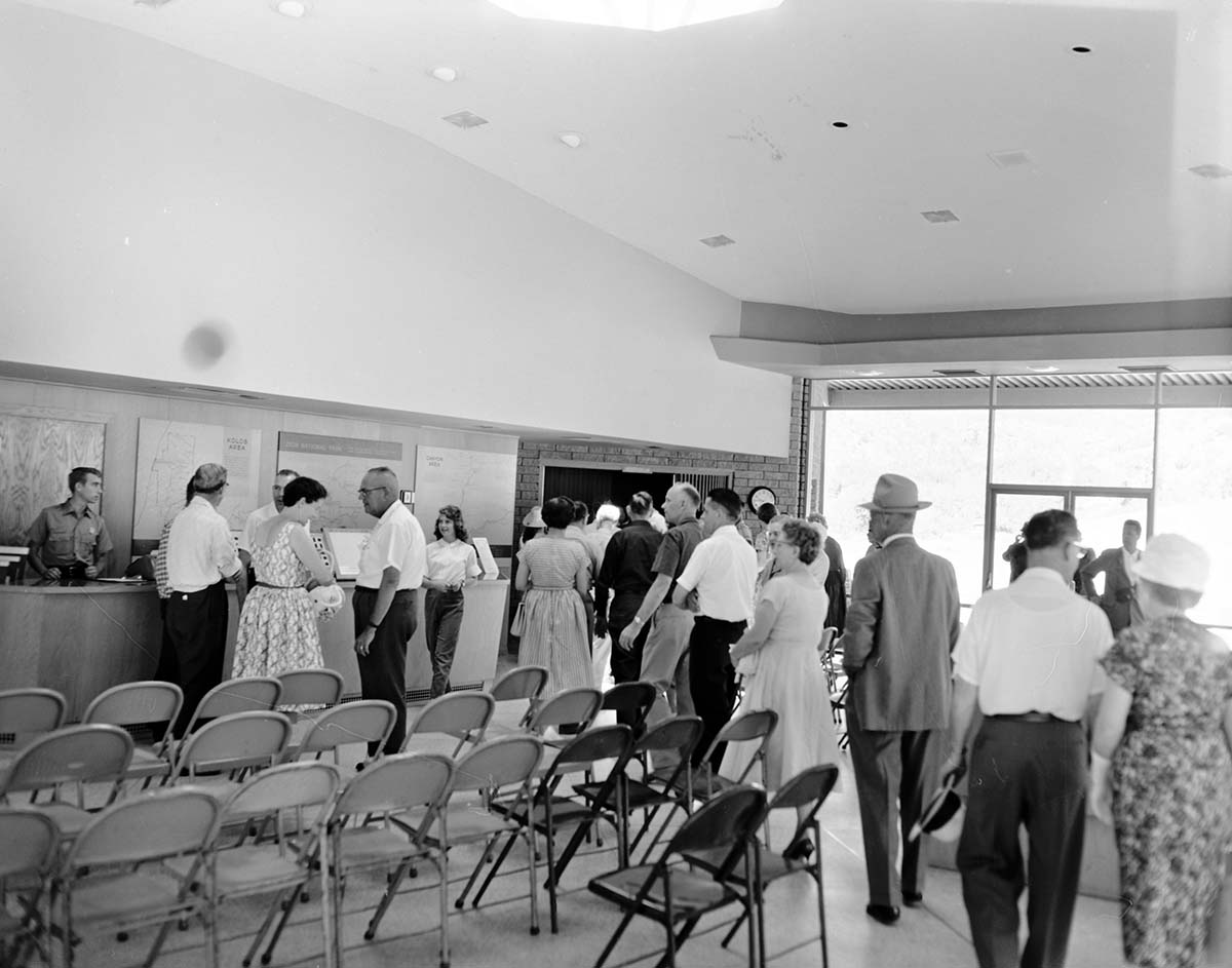 Visitors walk through lobby towards auditorium during the Mission 66 Visitor Center and Museum dedication.