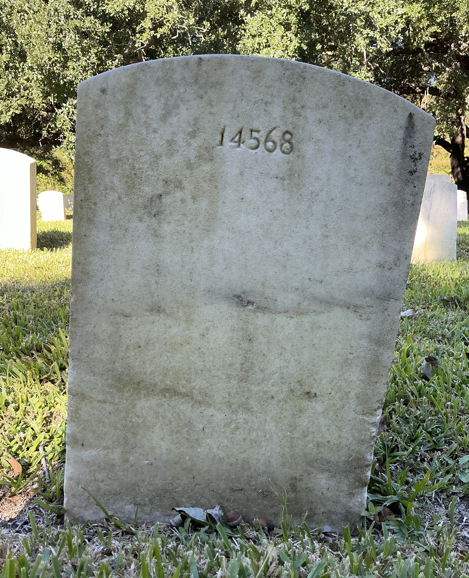 Back of upright marble headstone with flat face.