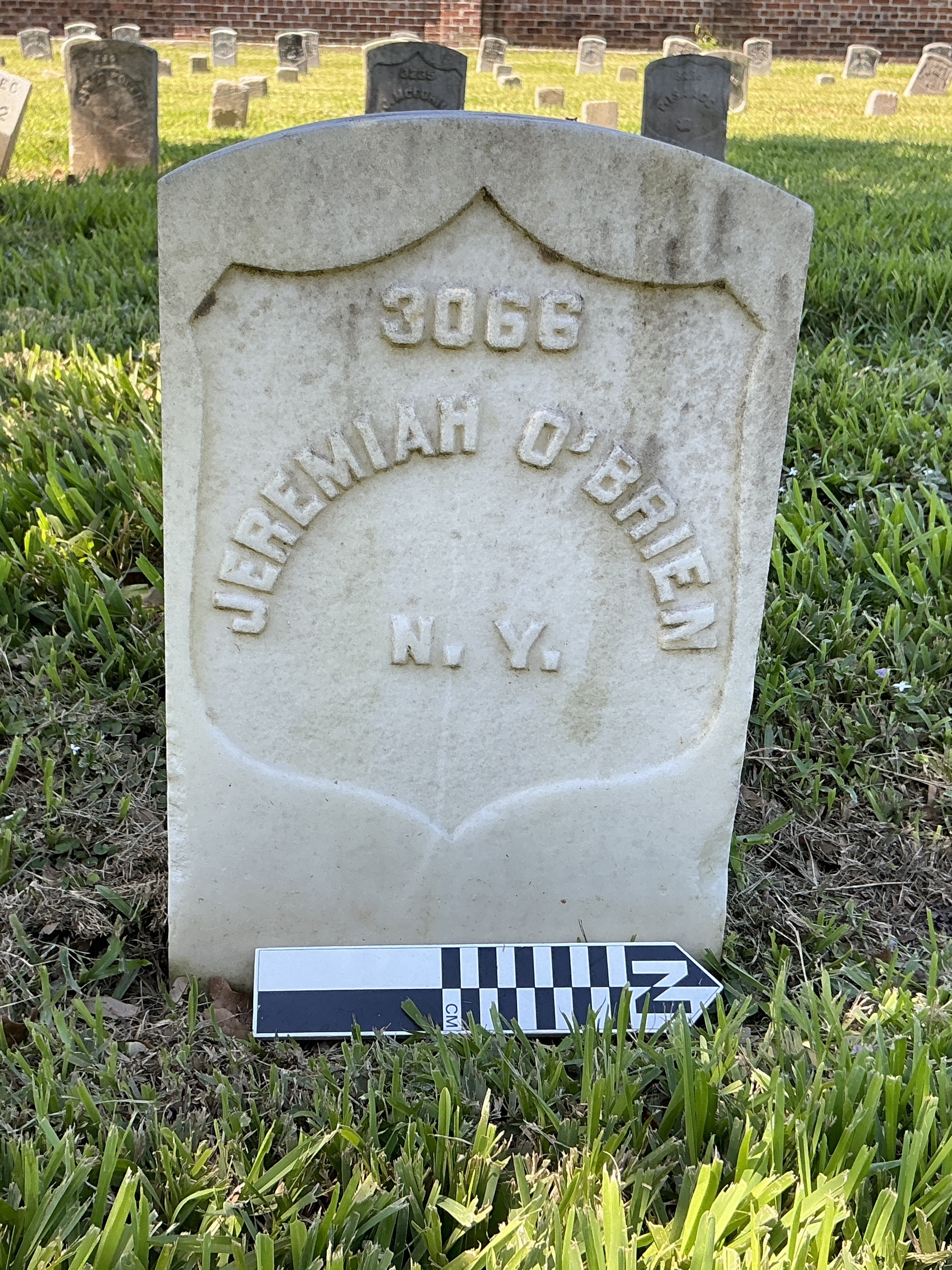 Extra image of historic upright marble headstone with recessed shield face.